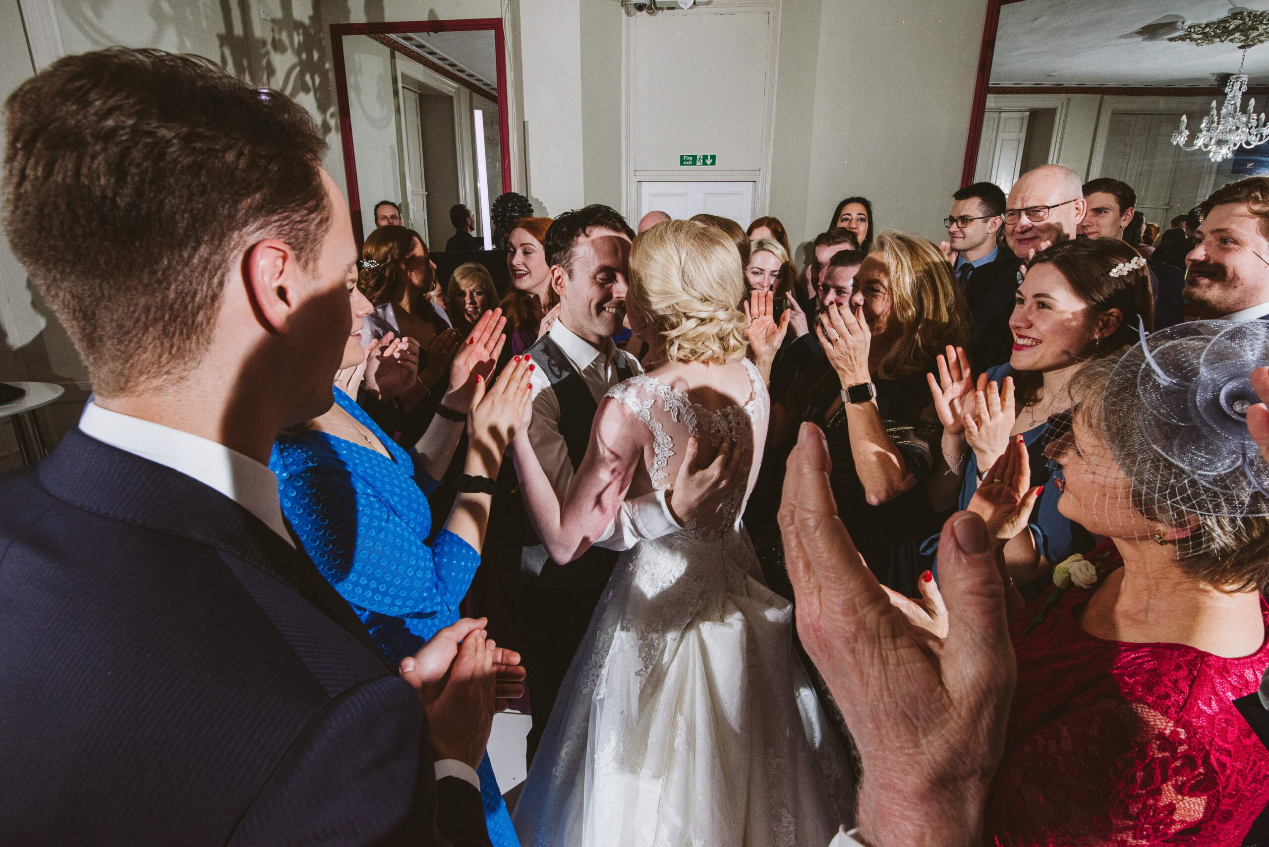 Couple dancing their first dance with guests around them